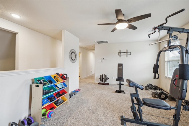 exercise area featuring ceiling fan and carpet floors