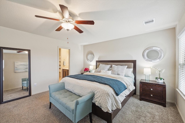 carpeted bedroom with connected bathroom and ceiling fan