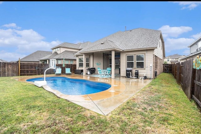 view of pool featuring ceiling fan, a patio area, and a lawn