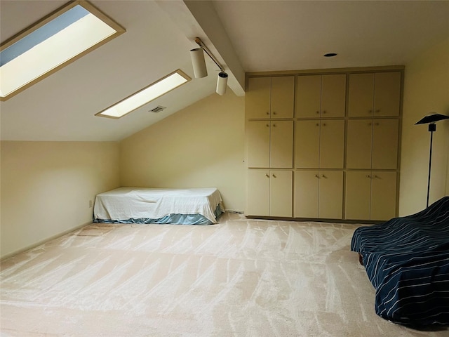 carpeted bedroom with vaulted ceiling with skylight