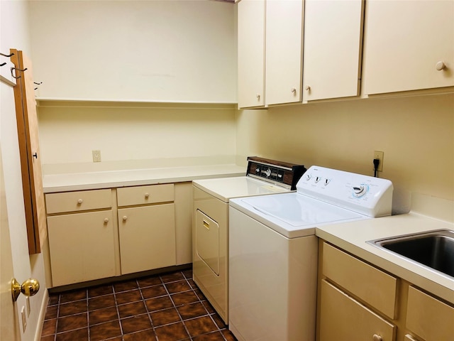 laundry area featuring cabinets, separate washer and dryer, and sink