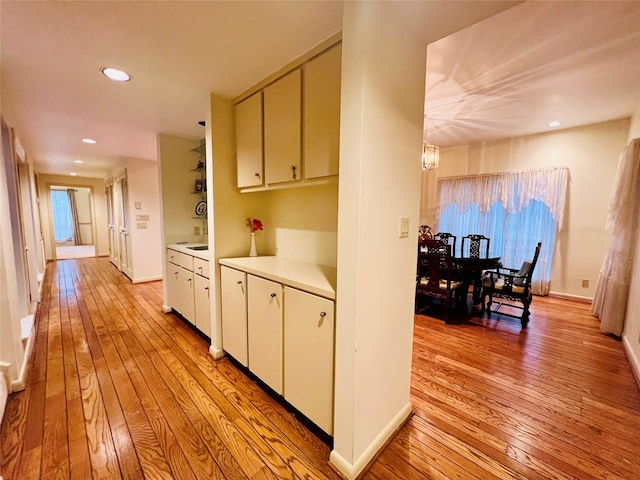 kitchen with an inviting chandelier, light hardwood / wood-style flooring, and a wealth of natural light