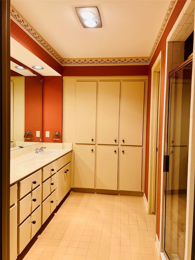 bathroom with tile patterned floors, vanity, and an enclosed shower