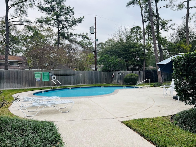 view of swimming pool with a patio