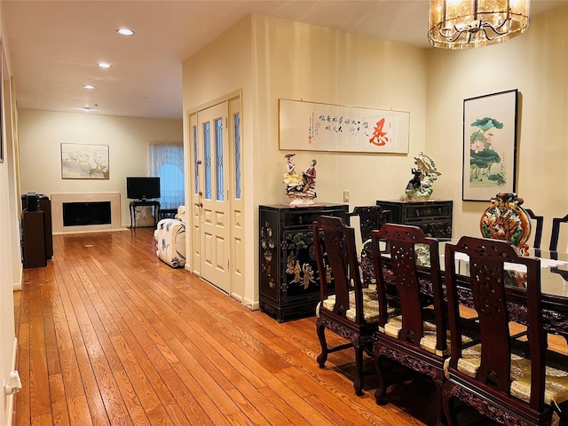 dining area featuring a notable chandelier and light wood-type flooring