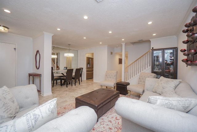 living room with ornamental molding and a textured ceiling