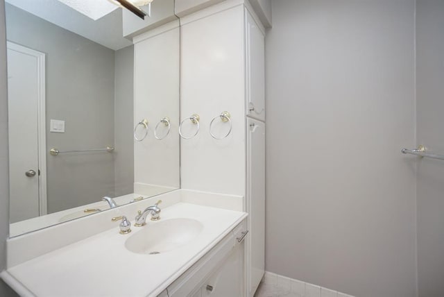 bathroom featuring vanity and a skylight