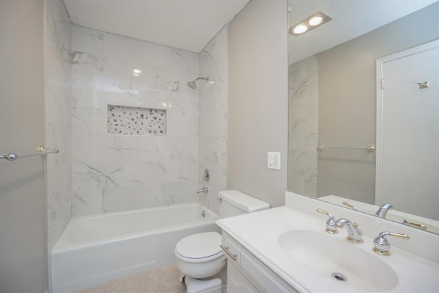 full bathroom featuring tile patterned floors, vanity, toilet, and tiled shower / bath