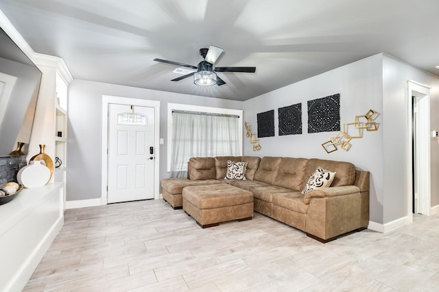 living room with ceiling fan and light hardwood / wood-style flooring