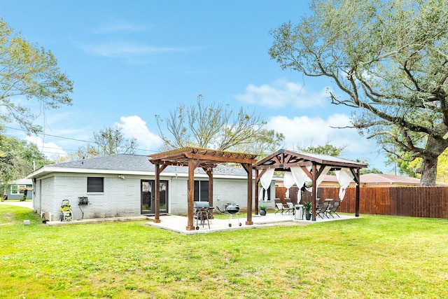 back of property featuring a pergola, a yard, and a patio