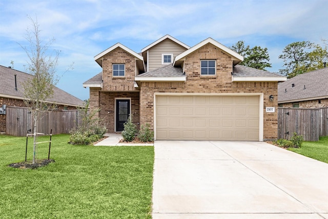 view of front of home featuring a front lawn and a garage