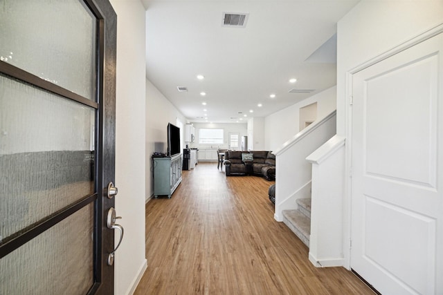 hall with light hardwood / wood-style flooring