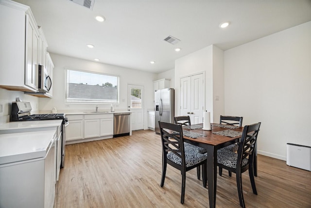 dining space featuring light hardwood / wood-style floors and sink