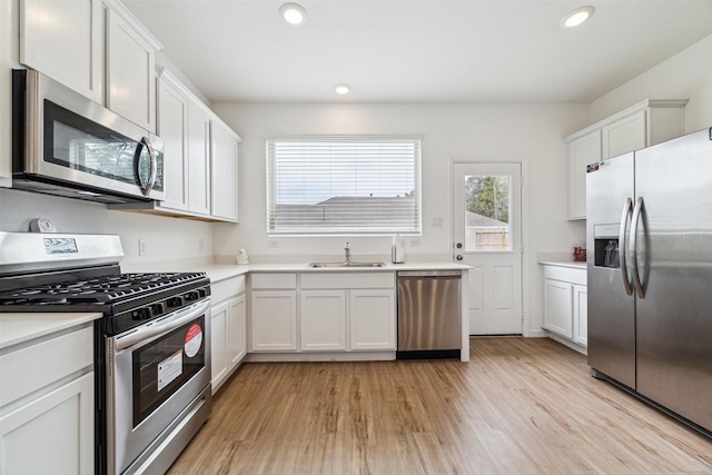 kitchen with white cabinets, appliances with stainless steel finishes, and sink