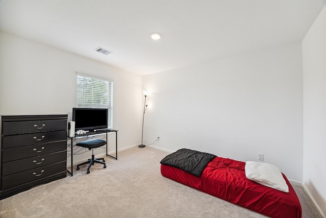 bedroom featuring light carpet