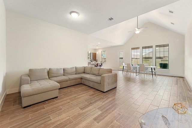 living room with ceiling fan and vaulted ceiling