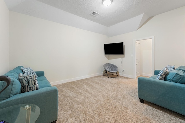 living room with lofted ceiling, carpet floors, and a textured ceiling