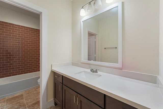 full bathroom with vanity, toilet, and tiled shower / bath