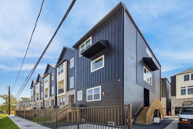 exterior space with a residential view, fence, and board and batten siding