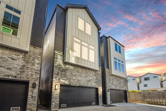 outdoor building at dusk featuring a garage