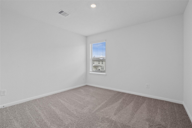 carpeted empty room with baseboards and visible vents