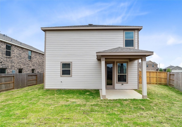 back of house with a fenced backyard, a yard, and a patio