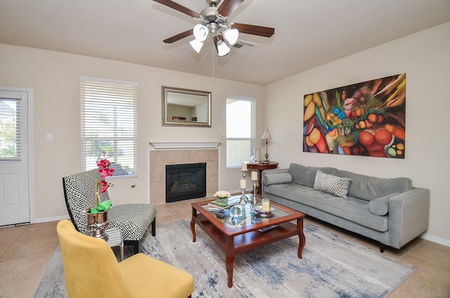 living room featuring ceiling fan, light tile patterned flooring, and a fireplace