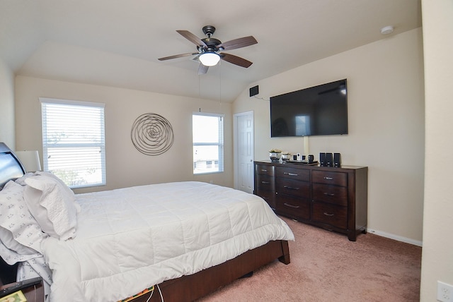 bedroom featuring multiple windows, ceiling fan, light carpet, and vaulted ceiling