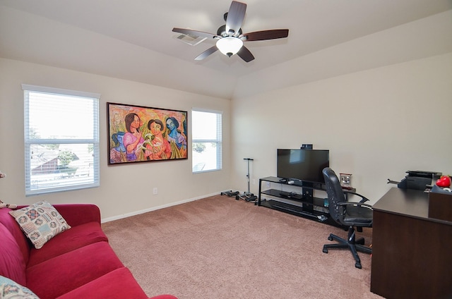 carpeted office space featuring vaulted ceiling, ceiling fan, and a healthy amount of sunlight