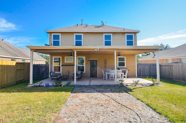 back of house with ceiling fan, a patio area, and a yard