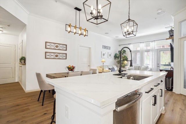 kitchen featuring sink, pendant lighting, a center island with sink, dishwasher, and white cabinets