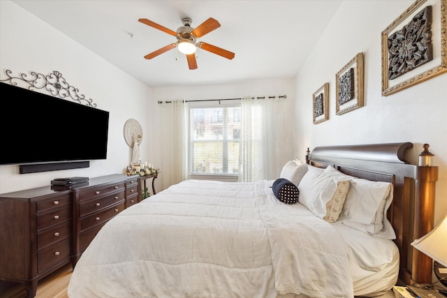 bedroom with light hardwood / wood-style floors and ceiling fan