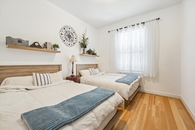 bedroom featuring lofted ceiling and hardwood / wood-style flooring