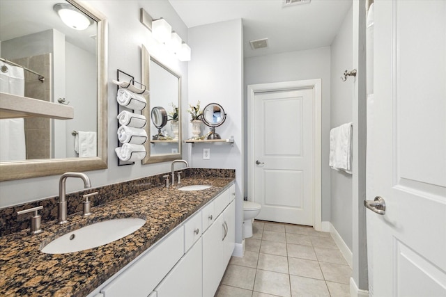 bathroom featuring tile patterned flooring, vanity, and toilet