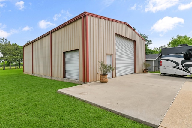 garage featuring a lawn