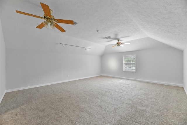 bonus room featuring carpet flooring, a textured ceiling, ceiling fan, and lofted ceiling