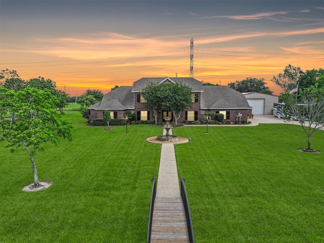 view of front of house featuring a lawn and a garage