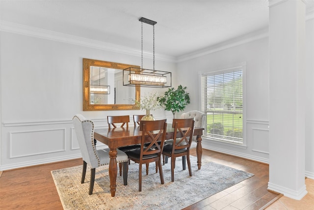 dining room featuring light wood-type flooring and ornamental molding