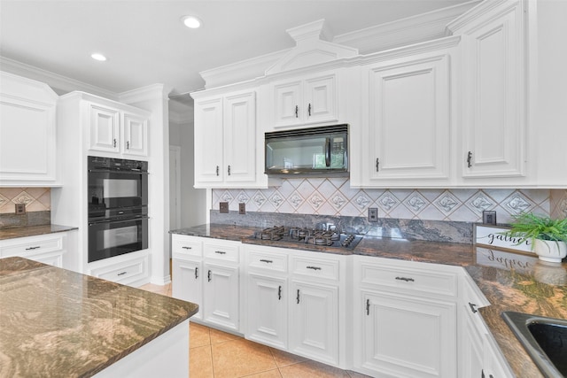 kitchen featuring white cabinets, light tile patterned floors, ornamental molding, and black appliances