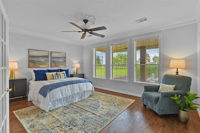 bedroom with dark wood-type flooring, ceiling fan, and crown molding