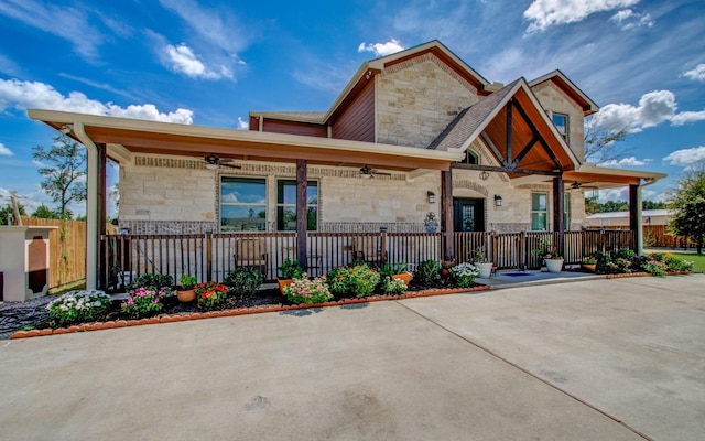 view of front of house with ceiling fan and a porch