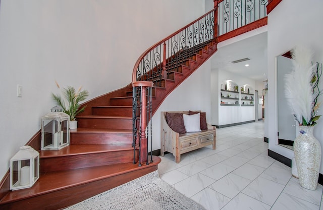 stairway featuring a high ceiling