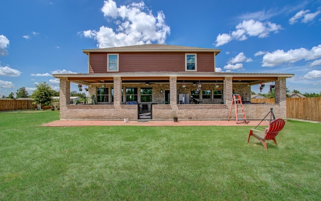 back of house with a lawn and a patio area