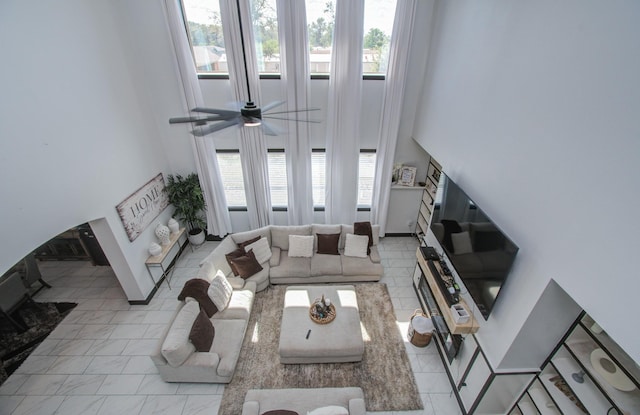 living room with plenty of natural light and a high ceiling