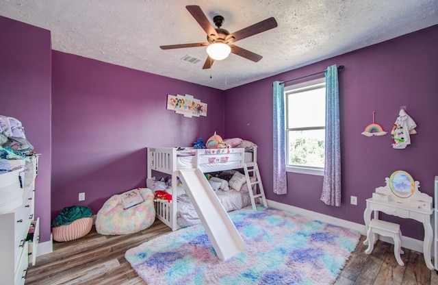 bedroom featuring a textured ceiling, hardwood / wood-style flooring, and ceiling fan