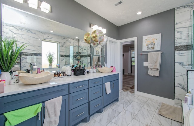 bathroom featuring vanity and a shower with shower door