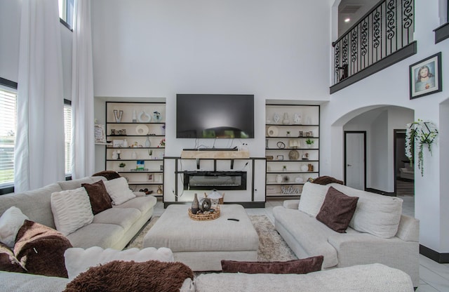 living room featuring a towering ceiling