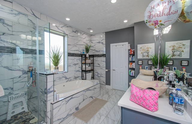 bathroom featuring vanity and independent shower and bath