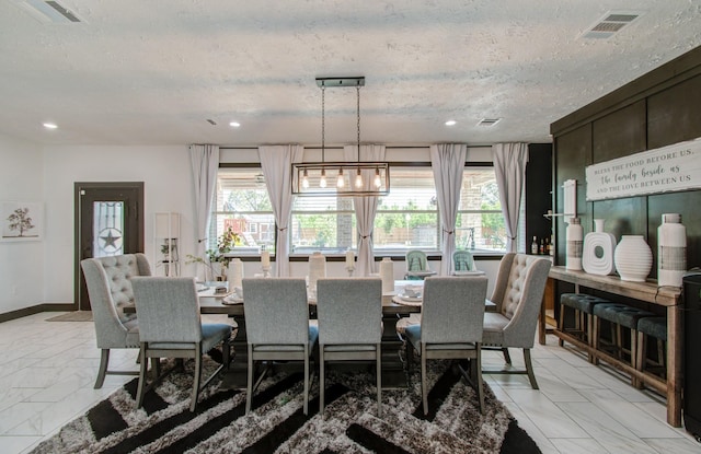 dining area featuring a textured ceiling