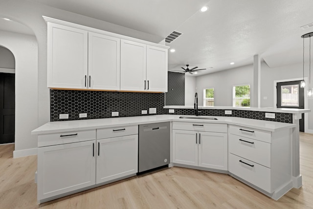 kitchen featuring stainless steel dishwasher, white cabinetry, and sink